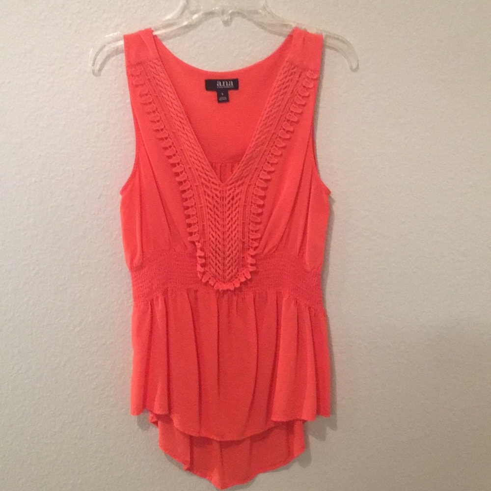 Salmon colored, sleeveless summer top.